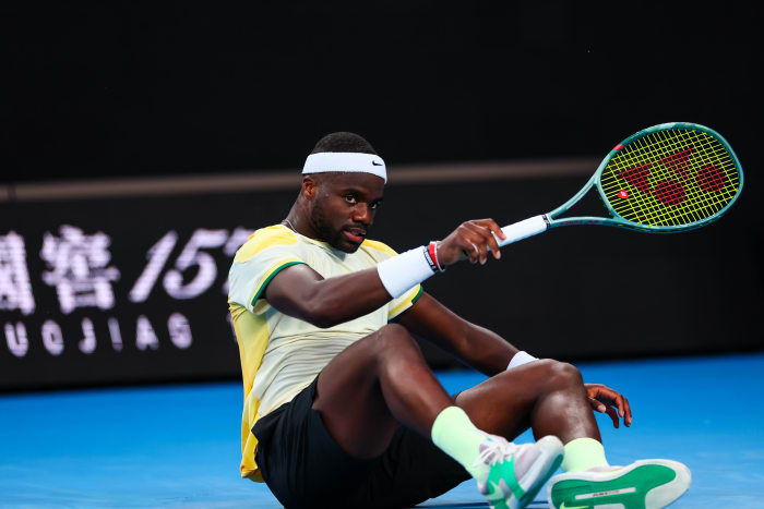 Frances Tiafoe falls on the court during the 2024 Australian Open.